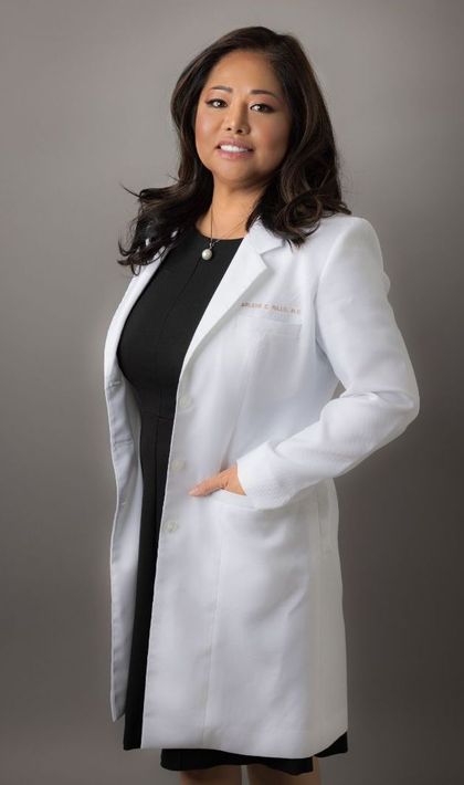 Dr. Arlene Rillo wearing a white physician coat