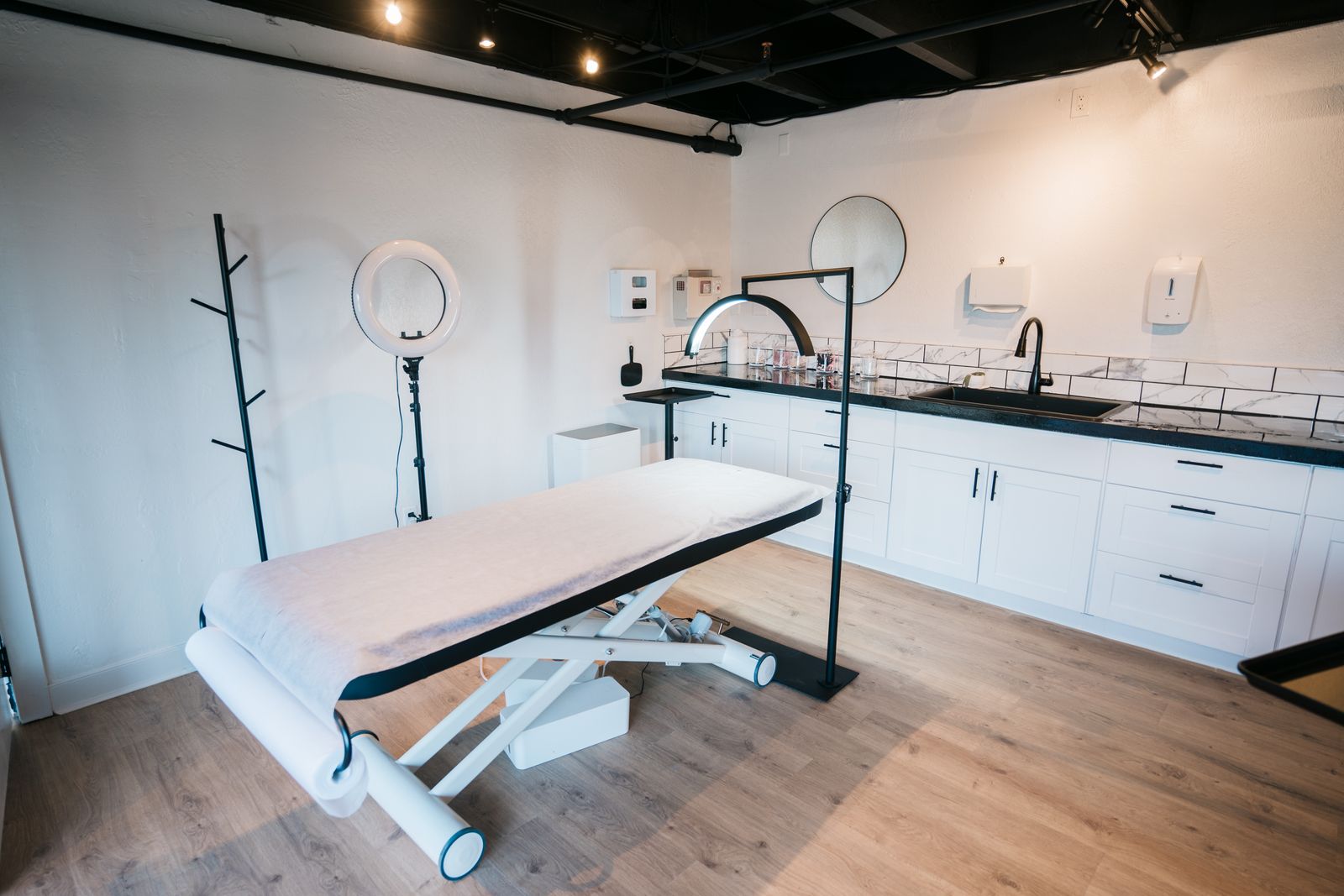Contemporary medical aesthetics treatment room with clinical equipment